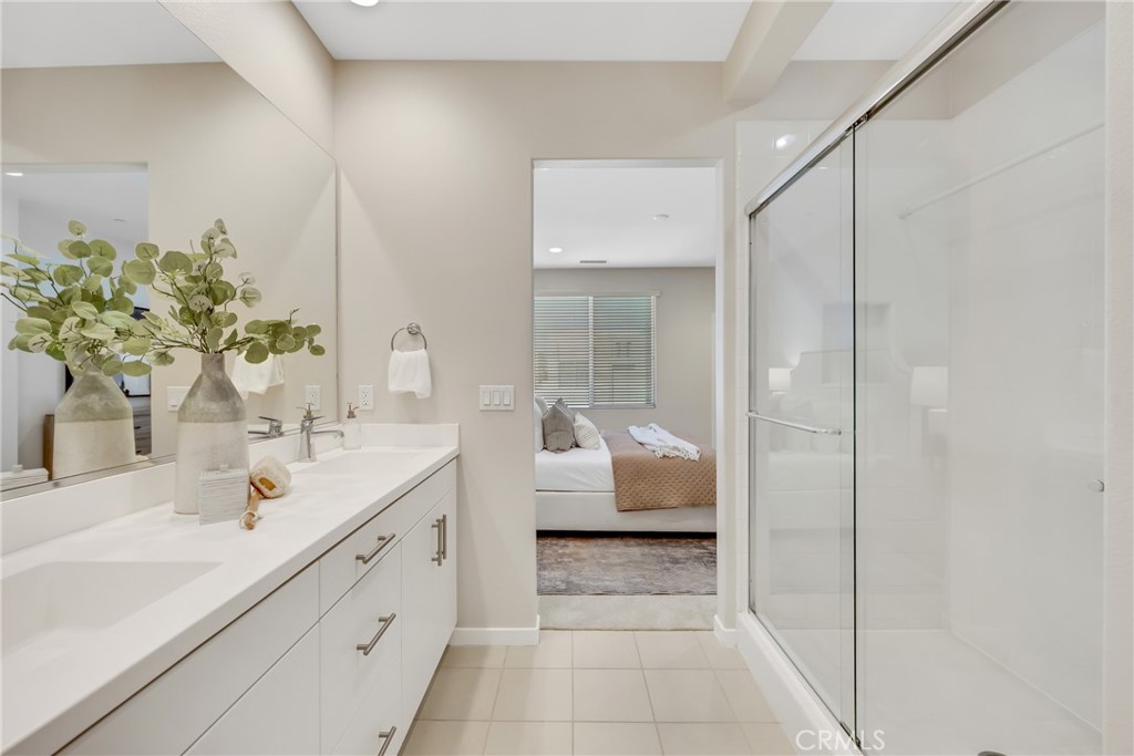 181 Magnet Irvine, CA 92618 - Photo 35 of 45 a en suite bathroom with a double vanity sink and mirror