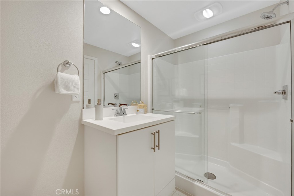 181 Magnet Irvine, CA 92618 - Photo 8 of 45 a bathroom with a shower sink vanity and mirror