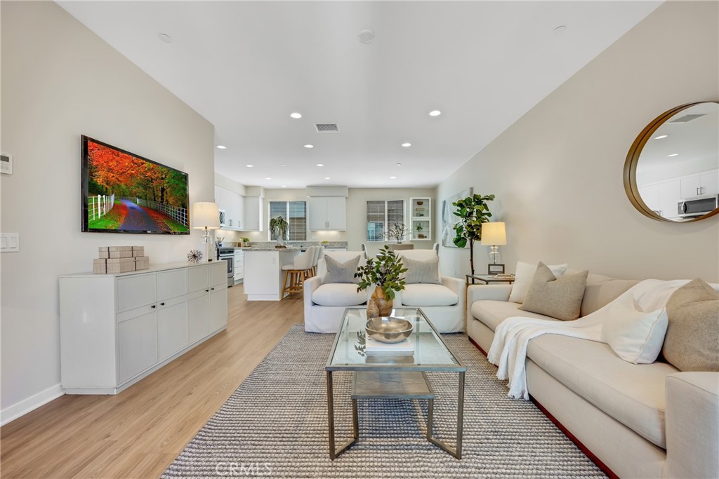 181 Magnet Irvine, CA 92618 - Photo 10 of 45 a living room with furniture a flat screen tv and kitchen view