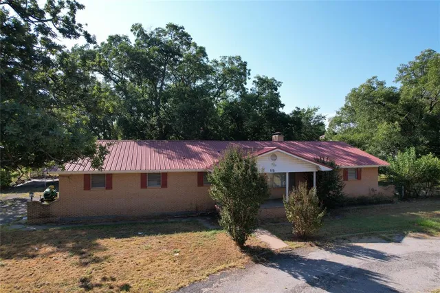 a view of a house with a yard and sitting area