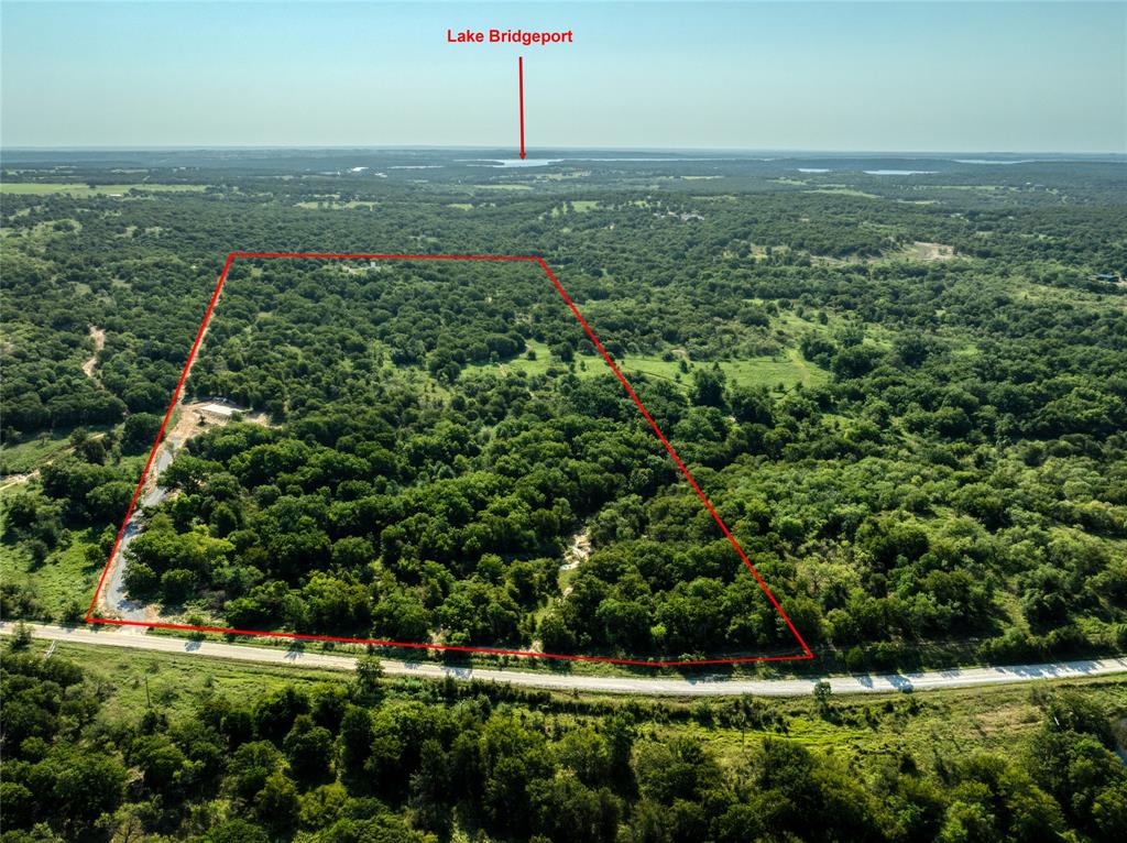 2913 County Line Road Chico, TX 76431 - Photo 14 of 18 a view of a green field with lots of bushes