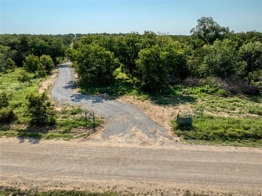 2913 County Line Road Chico, TX 76431 - Photo 5 of 18 an aerial view of a house with a yard and greenery