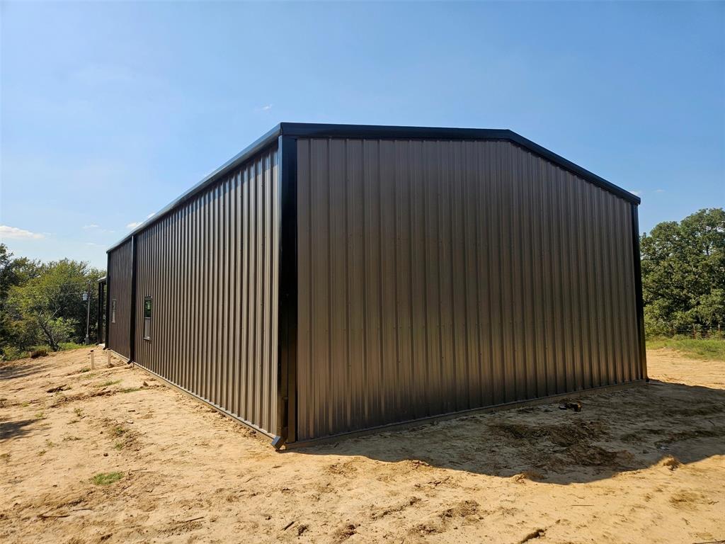 2913 County Line Road Chico, TX 76431 - Photo 10 of 18 a view of a backyard of a house