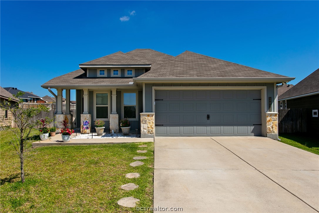 2071 Positano Loop Bryan, TX 77808 - Photo 2 of 31 a front view of a house with garden