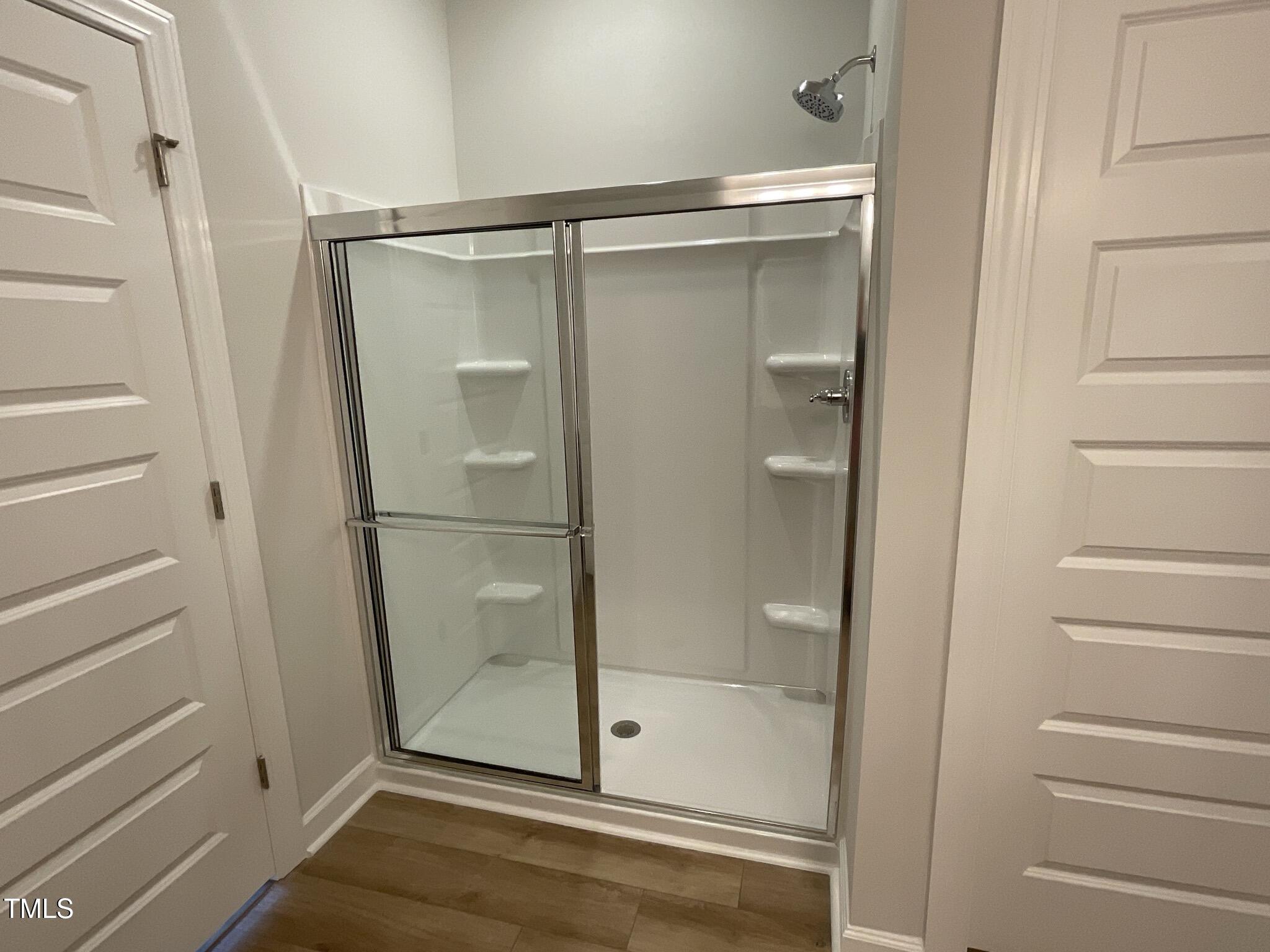 166 Nimble Way Clayton, NC 27520 - Photo 24 of 40 a bathroom with a glass shower door
