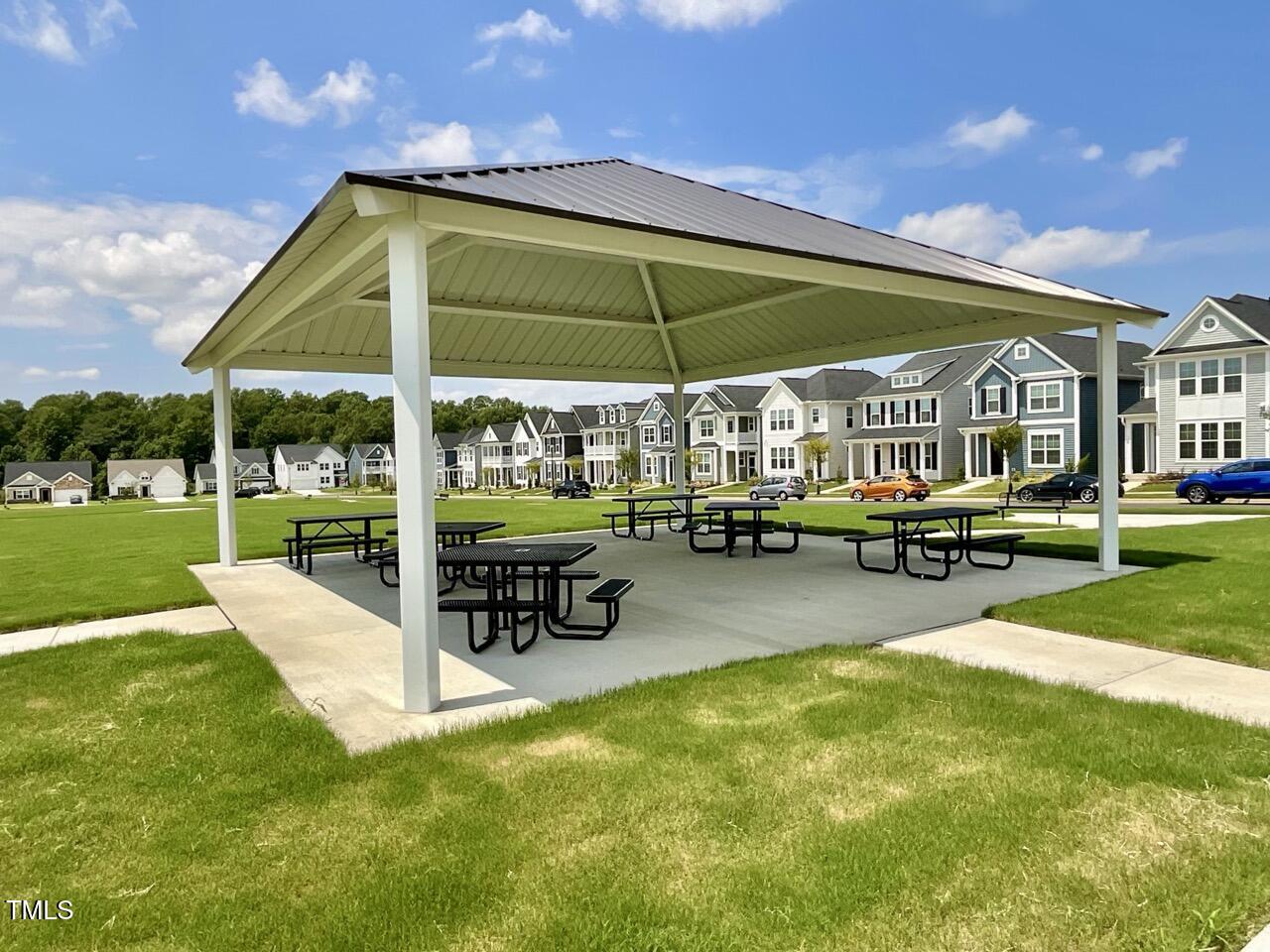 166 Nimble Way Clayton, NC 27520 - Photo 39 of 40 a view of a swimming pool with lawn chairs under an umbrella