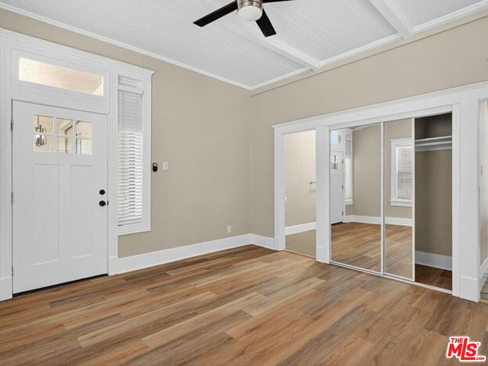 330 Cedar Avenue Long Beach, CA 90802 - Photo 13 of 18 an empty room with wooden floor cabinet and windows