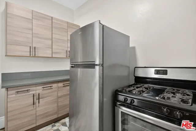 a stove top oven sitting inside of a kitchen