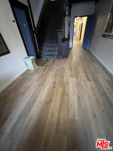 a view of entryway and hall with wooden floor
