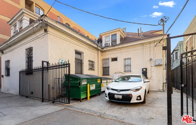 a car parked in front of a white building