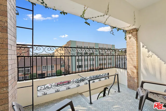 a view of a balcony with furniture