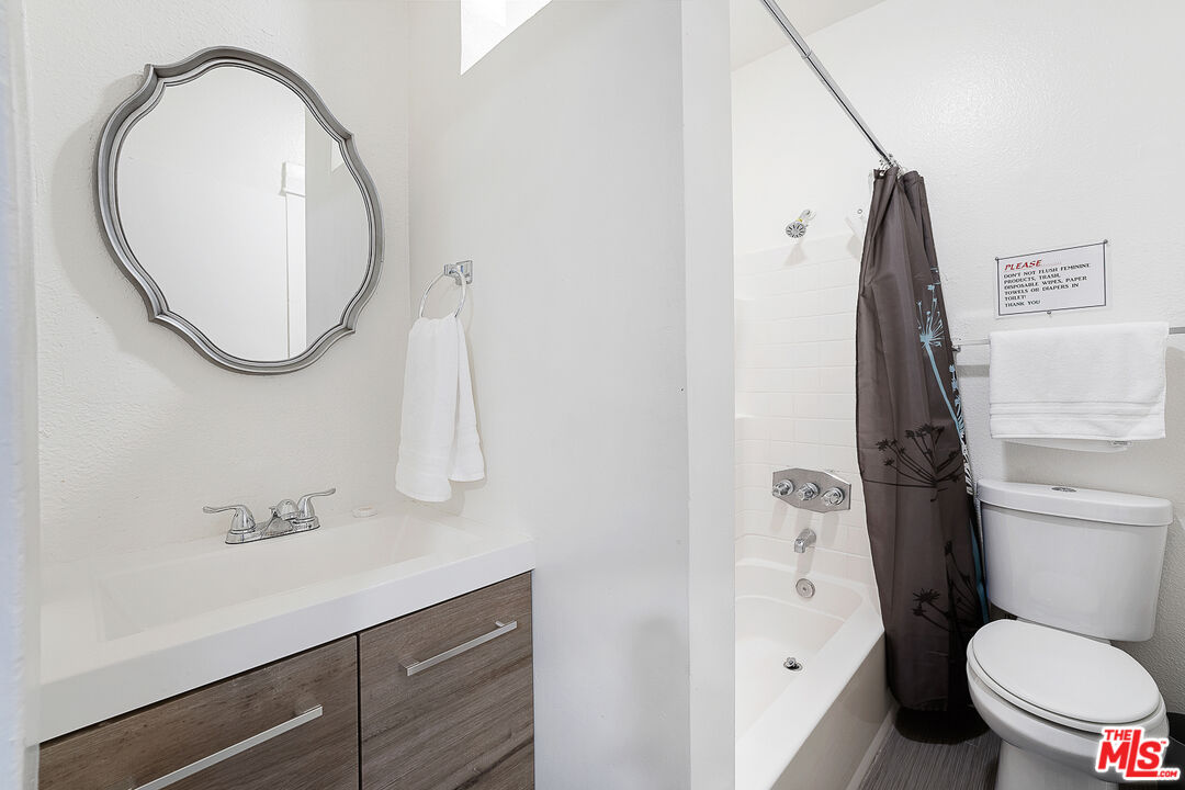 330 Cedar Avenue Long Beach, CA 90802 - Photo 8 of 18 a bathroom with a sink a toilet and a mirror