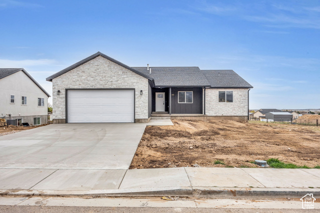 545 North 230th Street East Fillmore, UT 84631 - Photo 1 of 1 Single story home featuring stone siding, an attached garage, cooling unit, and driveway