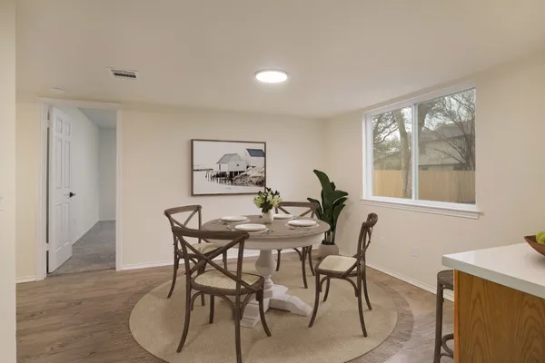 a dining room with furniture and window