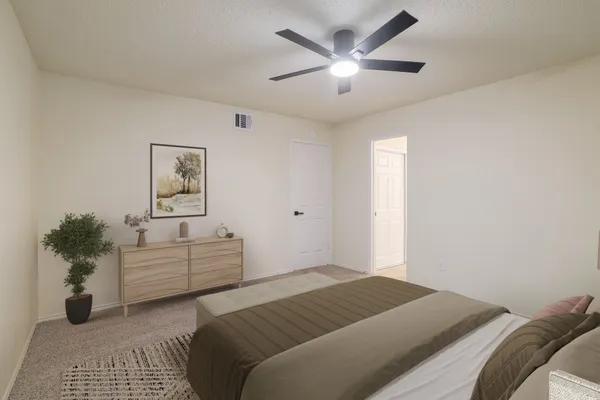 a bedroom with a large bed and a chandelier