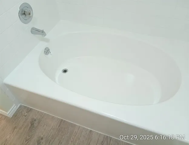 a bath tub sitting next to a shower