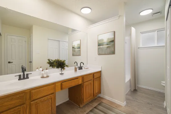 a bathroom with a double vanity sink mirror and