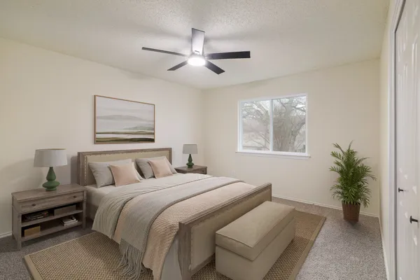 a bedroom with a bed and a potted plant