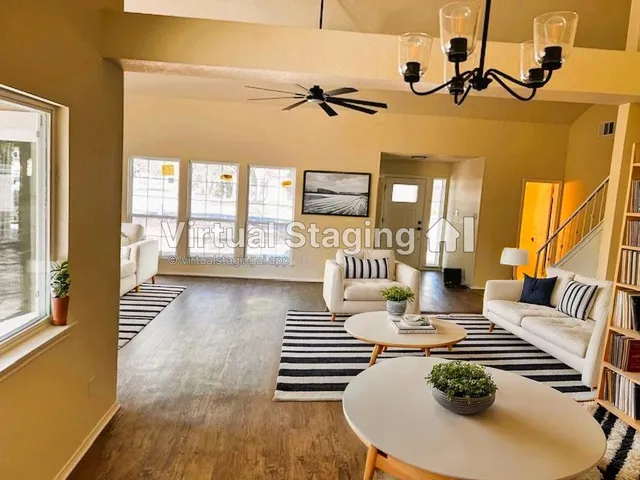 a living room with furniture and a wooden floor