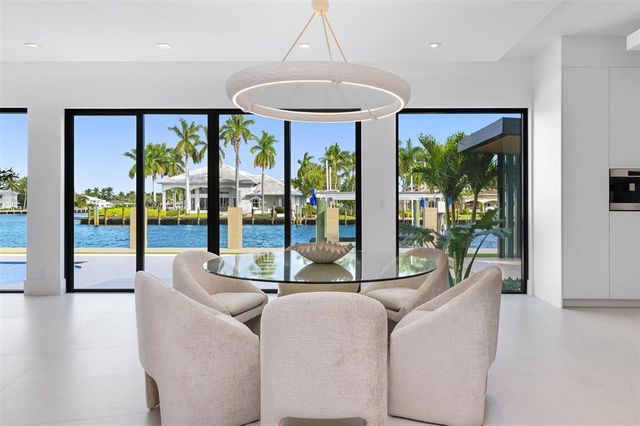 a living room with furniture flowerpot and a chandelier