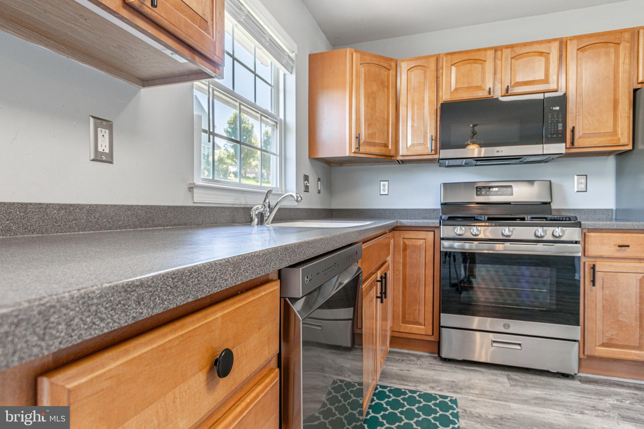 271 Courtney Court Spring Grove, PA 17362 - Photo 20 of 51 a kitchen with stainless steel appliances granite countertop a stove a sink and a microwave