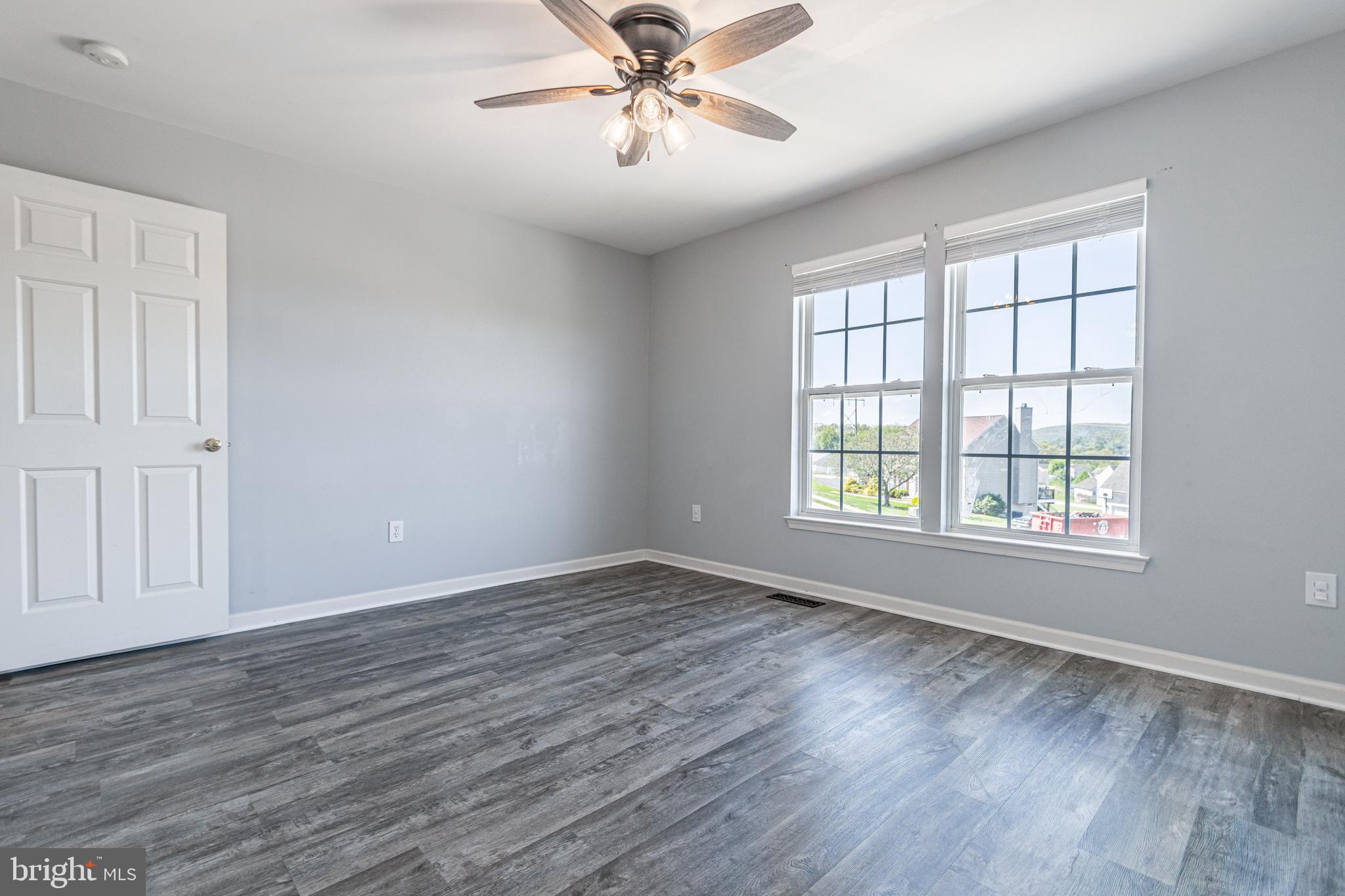 271 Courtney Court Spring Grove, PA 17362 - Photo 31 of 51 an empty room with wooden floor chandelier fan and windows