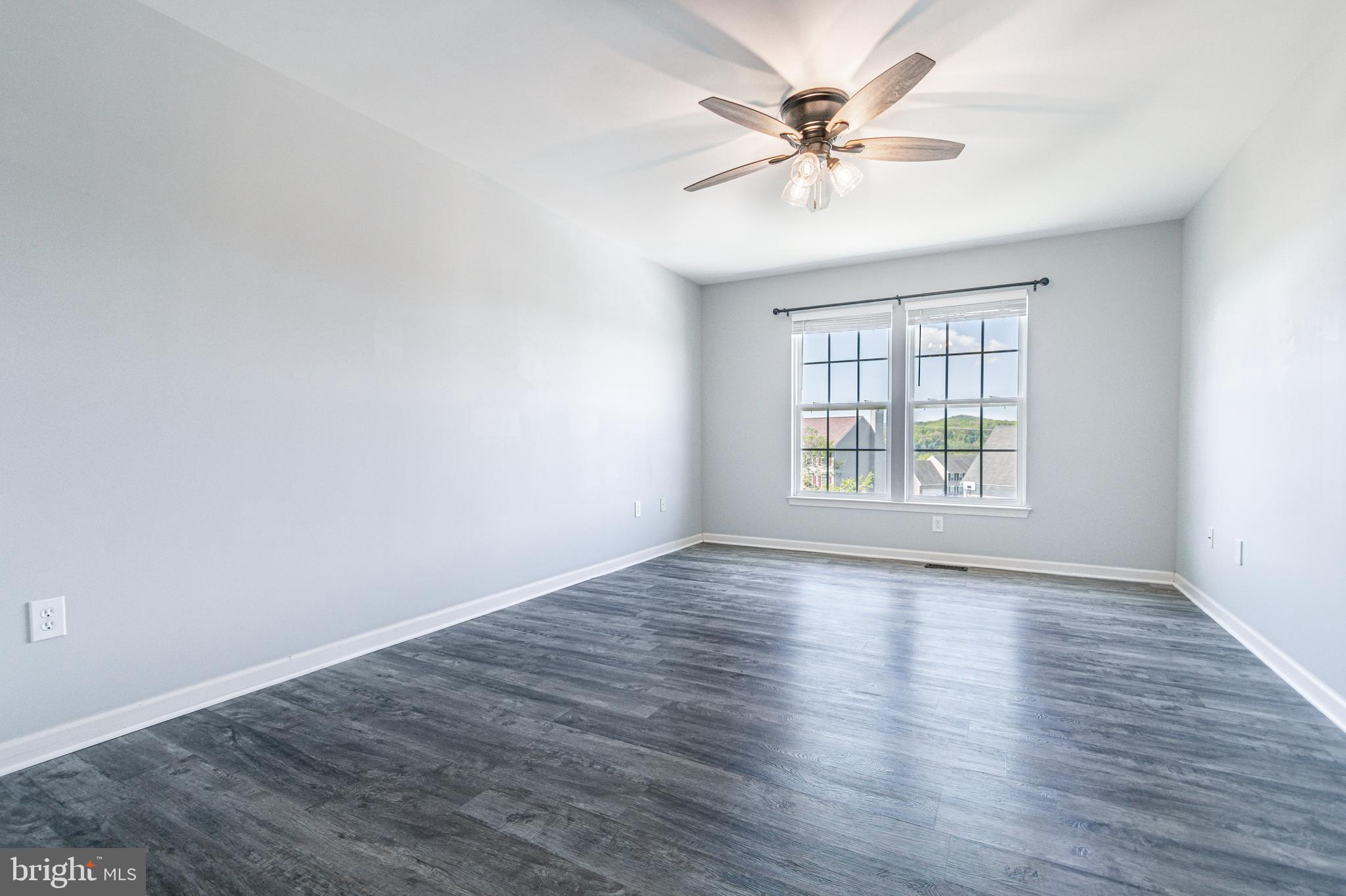 271 Courtney Court Spring Grove, PA 17362 - Photo 38 of 51 an empty room with wooden floor chandelier fan and windows