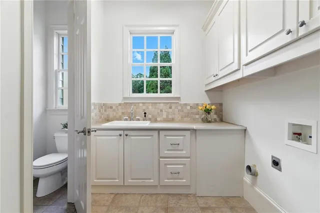 a view of a hallway view with wooden floor and a bathroom