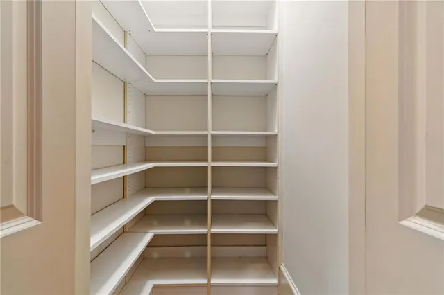 a kitchen with white cabinets and sink