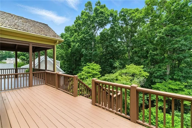 a view of an empty room with a chandelier and a window