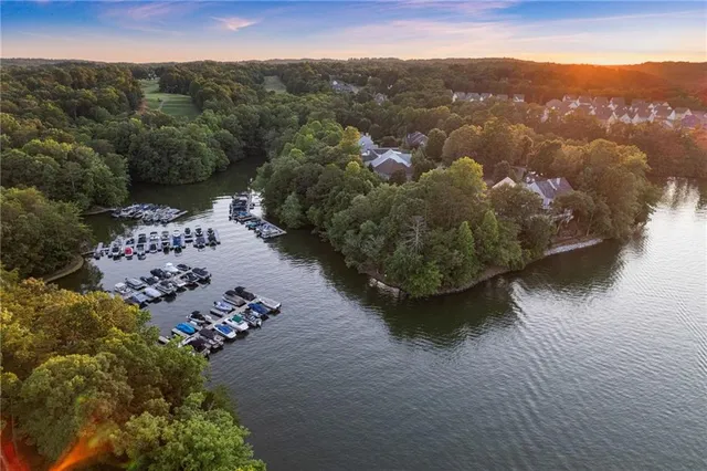 a kitchen with stainless steel appliances granite countertop a stove a sink dishwasher and a refrigerator with wooden floor