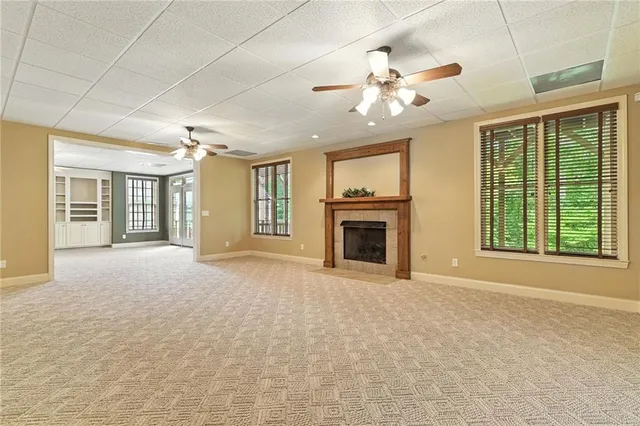 a living room with patio furniture and a large window