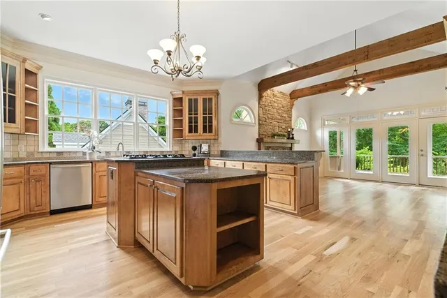a kitchen with stainless steel appliances granite countertop a stove and a refrigerator