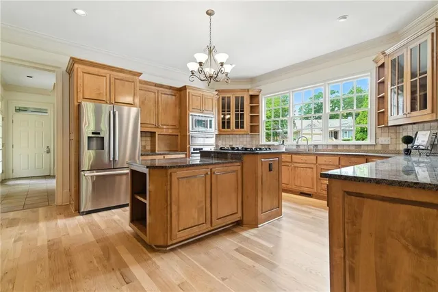 a view of an empty room with a window and fireplace