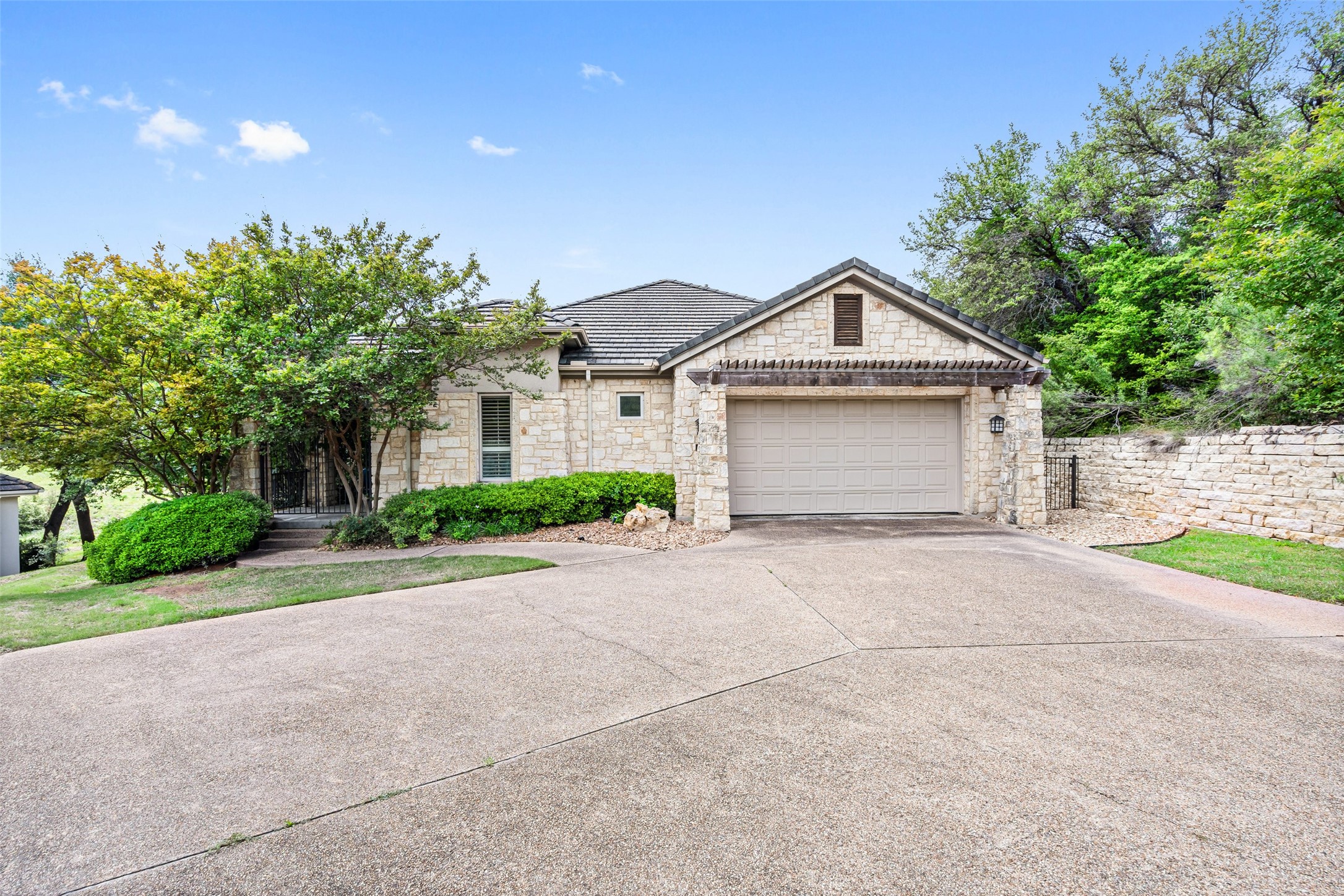 2305 Barton Creek Boulevard, Unit 1 Austin, TX 78735 - Photo 1 of 1 a front view of a house with a yard and garage