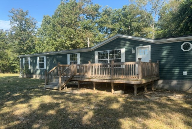 19188 East Divide Road Bluford, IL 62814 - Photo 1 of 20 a backyard of a house with table and chairs potted plants and large tree