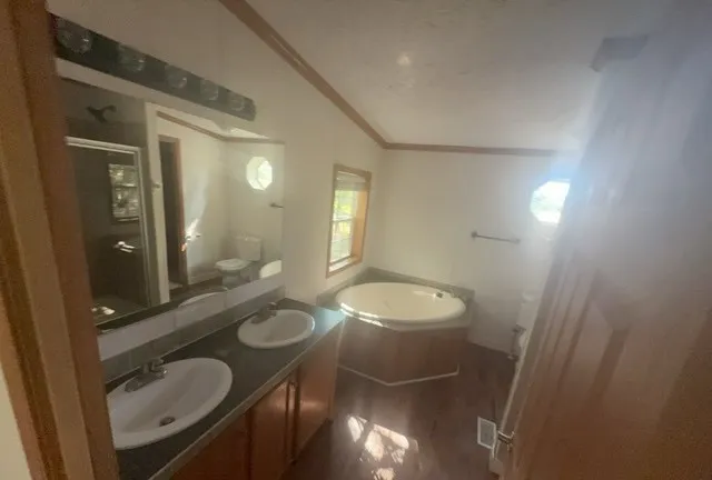 a bathroom with a double vanity sink and a mirror
