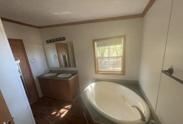 a bathroom with a sink a toilet and mirror