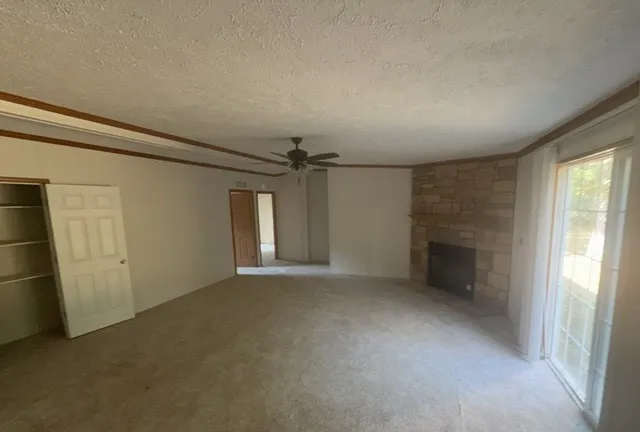 an empty room with closet and windows