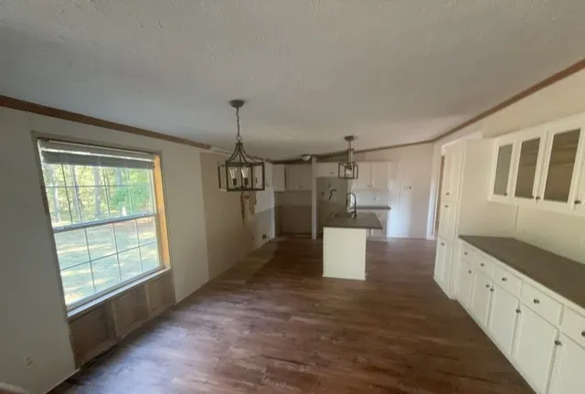 a view of a kitchen with a sink and dishwasher wooden floor