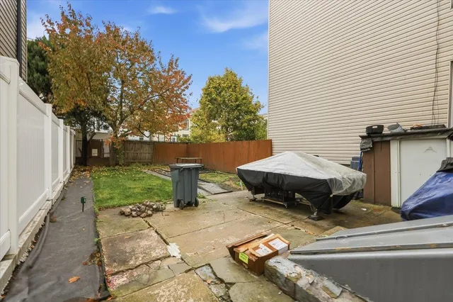 a backyard of a house with table and chairs