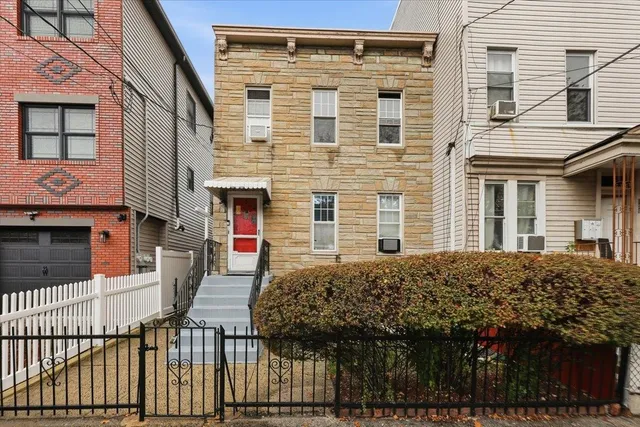 a view of a house with a balcony and door