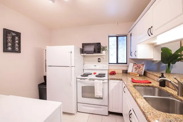a kitchen with a sink a stove and refrigerator