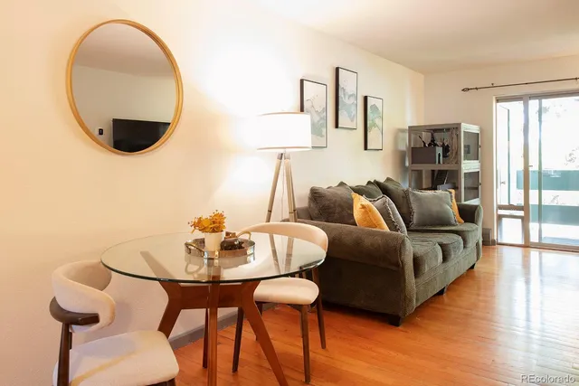 a living room with furniture and wooden floor