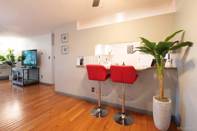 a dining room with furniture and wooden floor