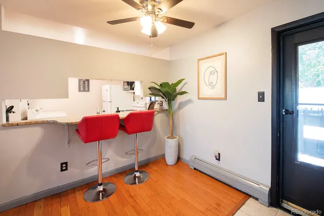 a room with table chairs and white walls
