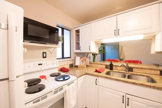 a kitchen with a sink and a stove top oven