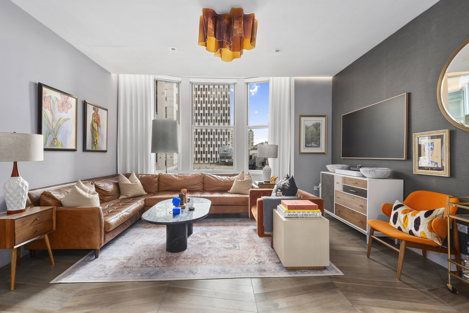 49 Chambers Street, Unit 8F Manhattan, NY 10007 - Photo 3 of 9 a living room with furniture and a flat screen tv