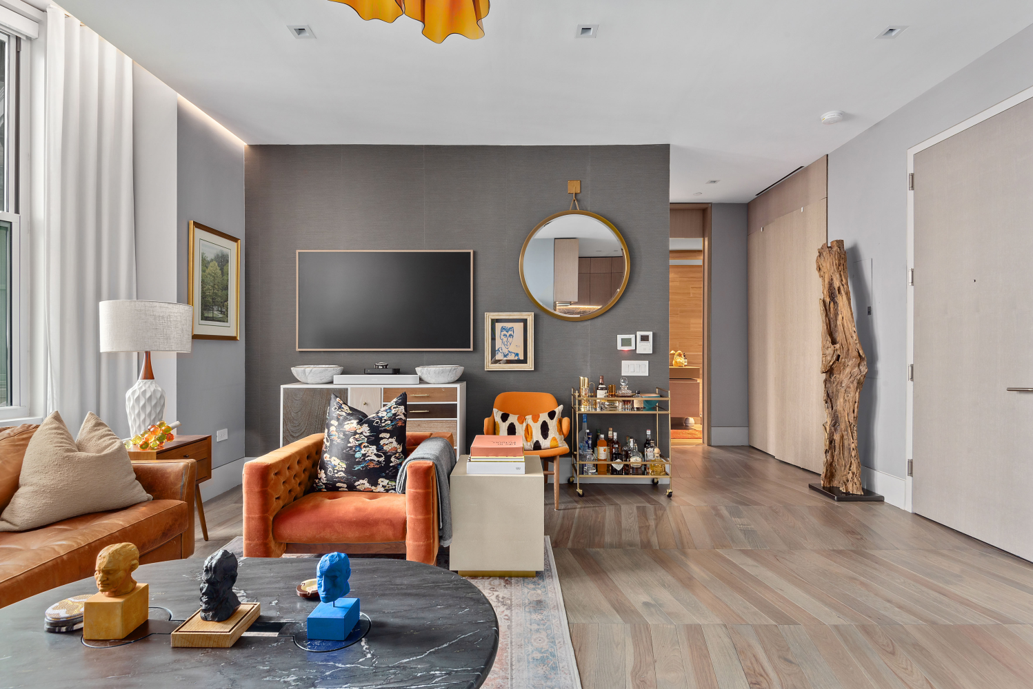 49 Chambers Street, Unit 8F Manhattan, NY 10007 - Photo 4 of 9 a living room with furniture and a flat screen tv