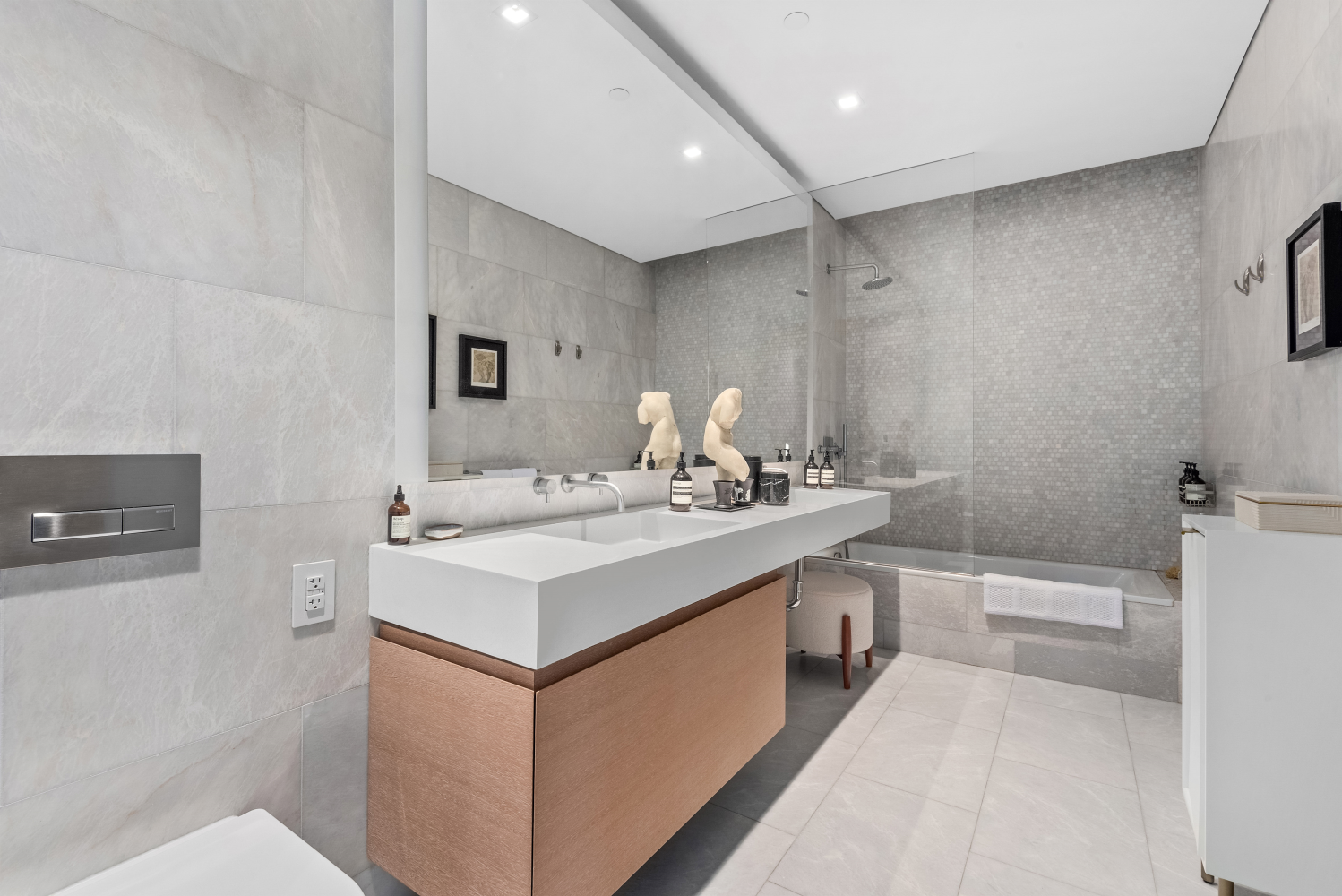 49 Chambers Street, Unit 8F Manhattan, NY 10007 - Photo 6 of 9 a bathroom with a sink a toilet and a mirror